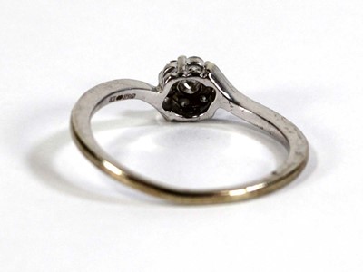 Lot 601 - A 9ct white gold cluster ring set seven small...