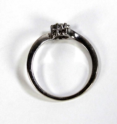 Lot 601 - A 9ct white gold cluster ring set seven small...