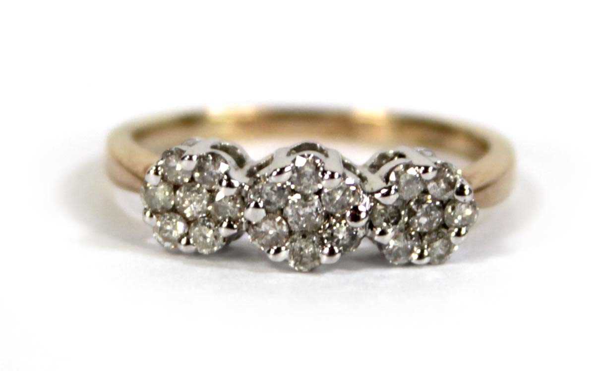 Lot 602 - A 9ct yellow gold triple cluster ring set...