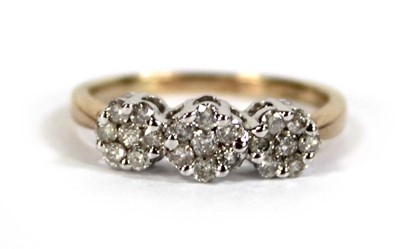 Lot 602 - A 9ct yellow gold triple cluster ring set...