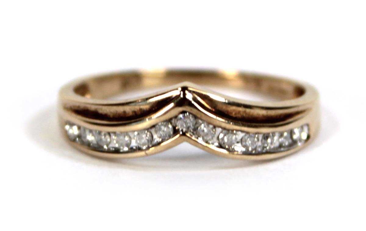 Lot 603 - A 9ct yellow gold ring set a row of small...