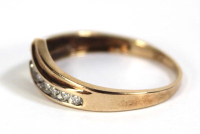 Lot 603 - A 9ct yellow gold ring set a row of small...