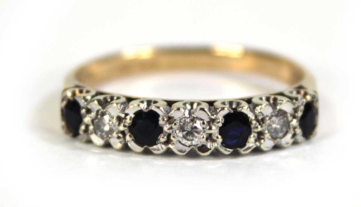 Lot 606 - A 9ct yellow gold half eternity ring set small...