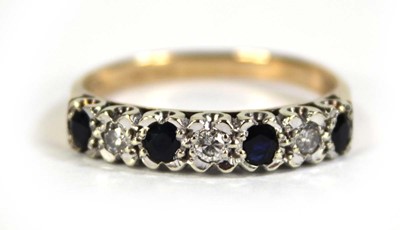 Lot 606 - A 9ct yellow gold half eternity ring set small...