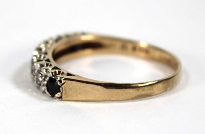 Lot 606 - A 9ct yellow gold half eternity ring set small...