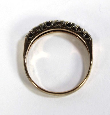 Lot 606 - A 9ct yellow gold half eternity ring set small...