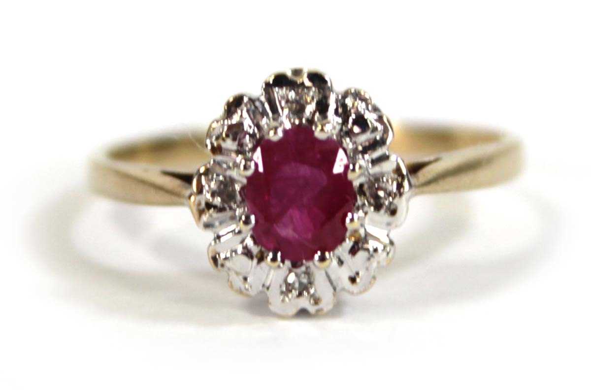 Lot 607 - A 9ct yellow gold cluster ring set oval ruby...