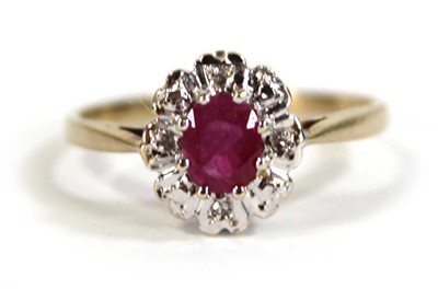 Lot 607 - A 9ct yellow gold cluster ring set oval ruby...