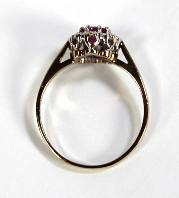 Lot 607 - A 9ct yellow gold cluster ring set oval ruby...