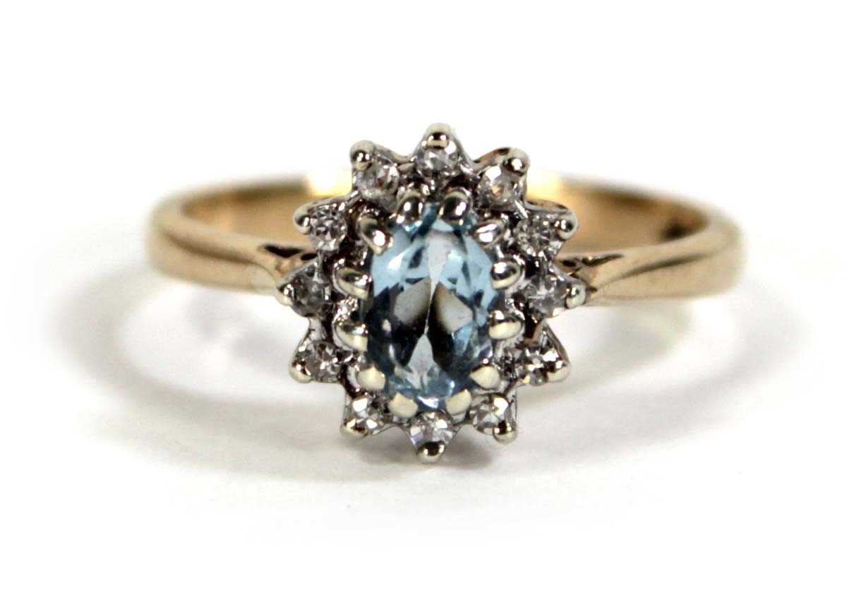 Lot 608 - A 9ct yellow gold cluster ring set pale blue...
