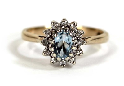 Lot 608 - A 9ct yellow gold cluster ring set pale blue...