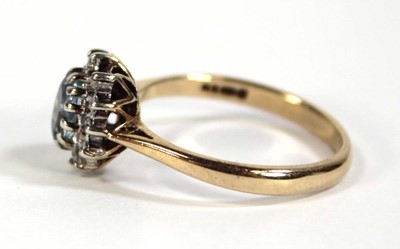 Lot 608 - A 9ct yellow gold cluster ring set pale blue...