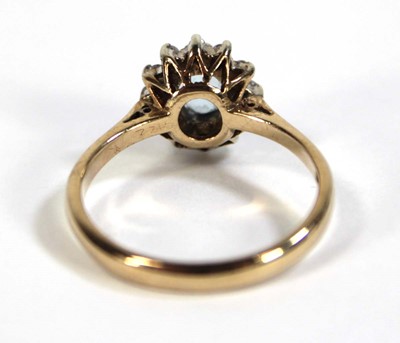 Lot 608 - A 9ct yellow gold cluster ring set pale blue...