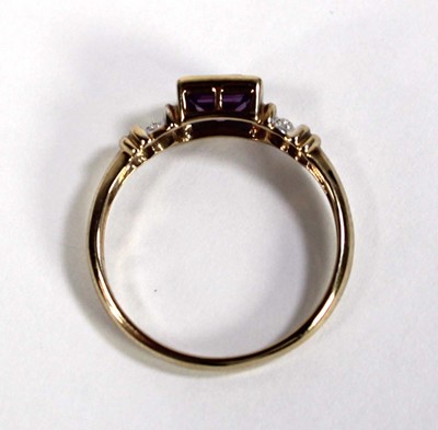 Lot 611 - A 9ct yellow gold ring set square cut amethyst...