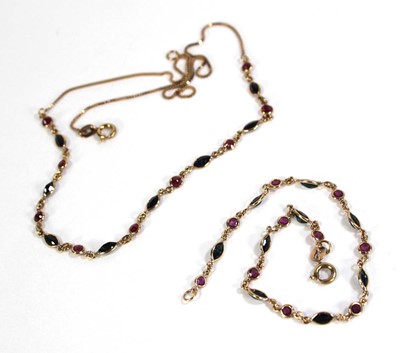 Lot 613 - A 9ct yellow gold necklace set nine small...