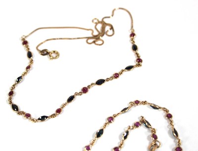 Lot 613 - A 9ct yellow gold necklace set nine small...