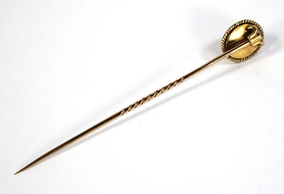 Lot 623 - A yellow metal stick pin set cabochon garnet...