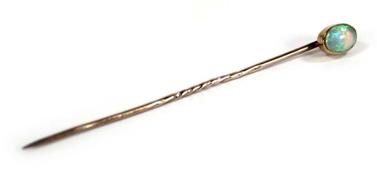 Lot 624 - A 15ct yellow gold stick pin set opal within a...