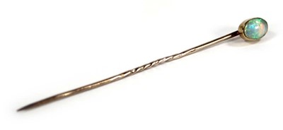 Lot 624 - A 15ct yellow gold stick pin set opal within a...