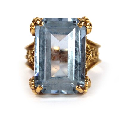 Lot 629 - A yellow metal ring set pale blue emerald cut...