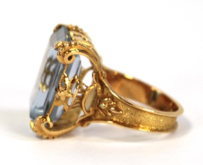 Lot 629 - A yellow metal ring set pale blue emerald cut...