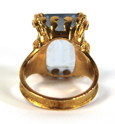 Lot 629 - A yellow metal ring set pale blue emerald cut...