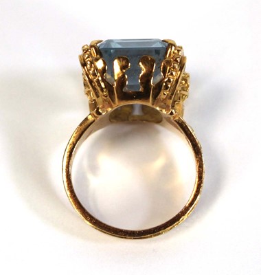 Lot 629 - A yellow metal ring set pale blue emerald cut...