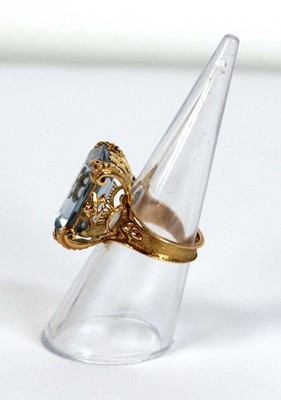 Lot 629 - A yellow metal ring set pale blue emerald cut...