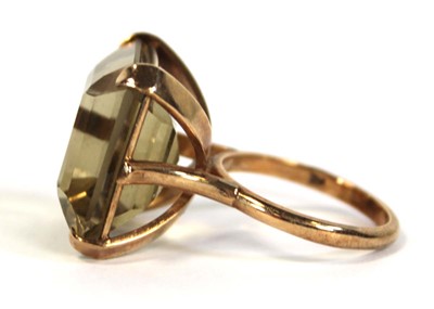 Lot 630 - A 9ct yellow gold dress ring set square cut...