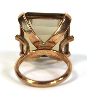 Lot 630 - A 9ct yellow gold dress ring set square cut...