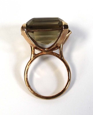 Lot 630 - A 9ct yellow gold dress ring set square cut...