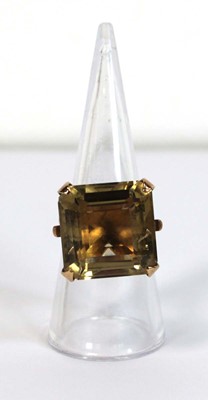 Lot 630 - A 9ct yellow gold dress ring set square cut...