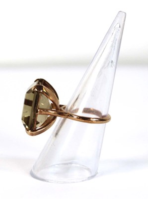 Lot 630 - A 9ct yellow gold dress ring set square cut...