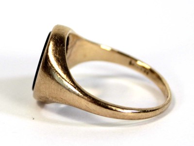 Lot 631 - A yellow metal pinky signet ring set black...