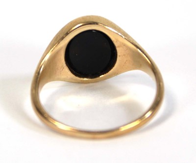 Lot 631 - A yellow metal pinky signet ring set black...
