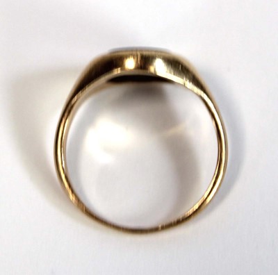 Lot 631 - A yellow metal pinky signet ring set black...