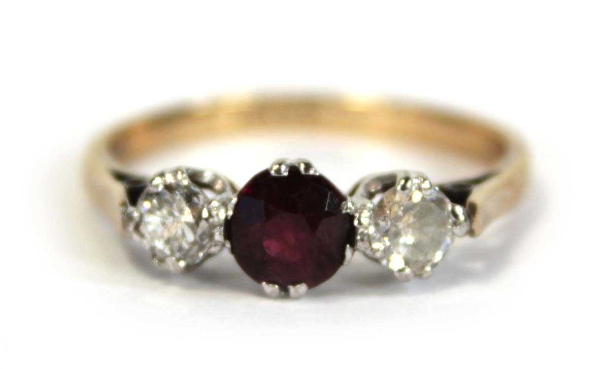 Lot 644 - An 18ct yellow gold ring set garnet and two...