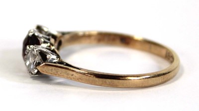 Lot 644 - An 18ct yellow gold ring set garnet and two...