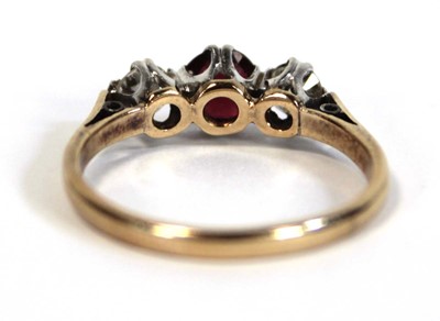 Lot 644 - An 18ct yellow gold ring set garnet and two...