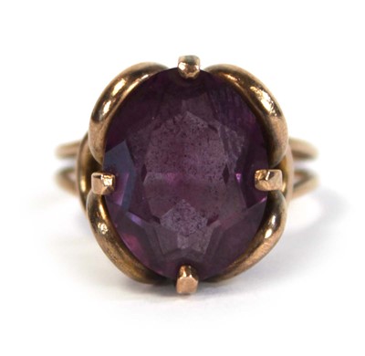 Lot 645 - A yellow metal ring set oval amethyst coloured...