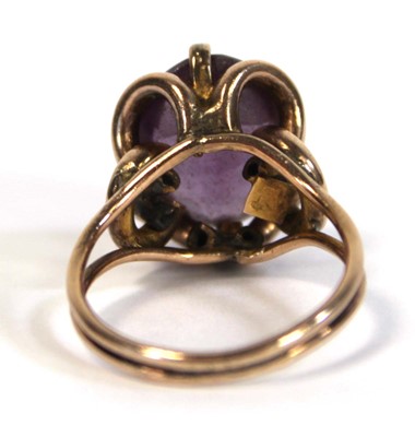 Lot 645 - A yellow metal ring set oval amethyst coloured...