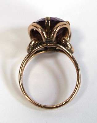 Lot 645 - A yellow metal ring set oval amethyst coloured...