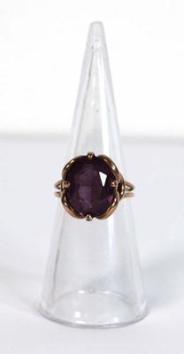 Lot 645 - A yellow metal ring set oval amethyst coloured...