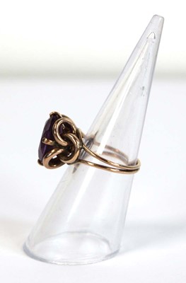 Lot 645 - A yellow metal ring set oval amethyst coloured...