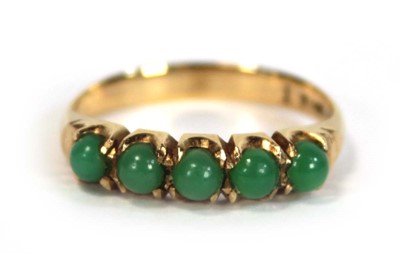 Lot 646 - A yellow metal ring set five small cabochon...