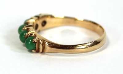 Lot 646 - A yellow metal ring set five small cabochon...