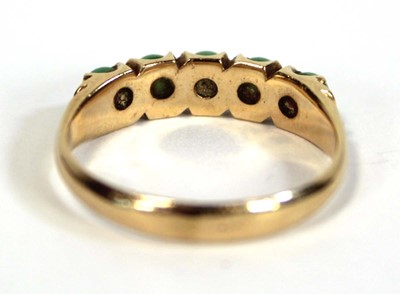 Lot 646 - A yellow metal ring set five small cabochon...