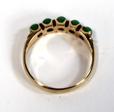 Lot 646 - A yellow metal ring set five small cabochon...