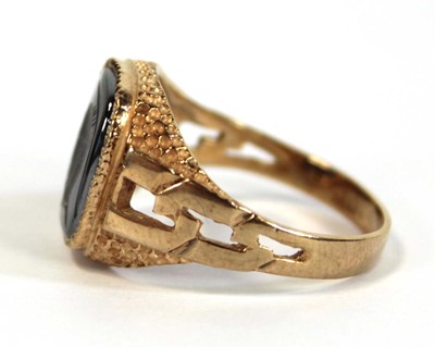 Lot 647 - A 9ct yellow gold signet ring set hematite...