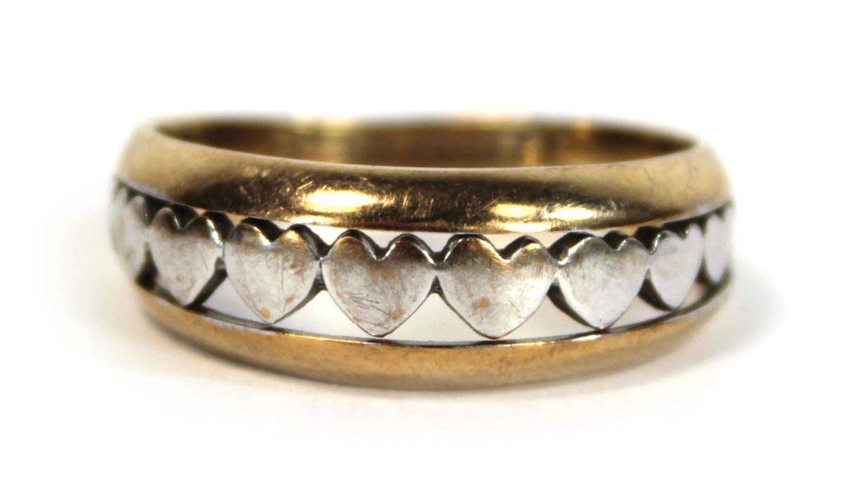 Lot 650 - A two colour metal tapered band ring decorated...